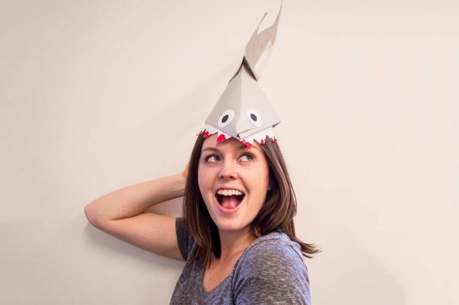 happy girl wearing shark hat 