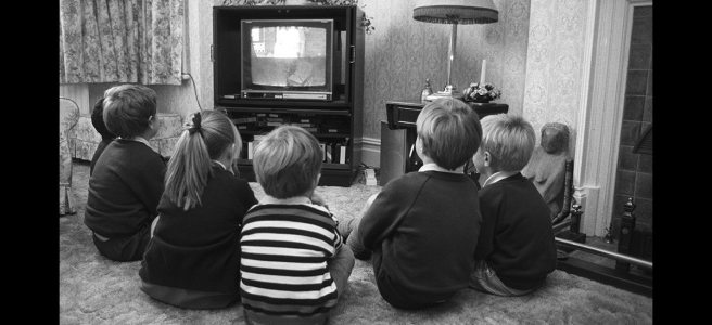 kids watching television in black and white